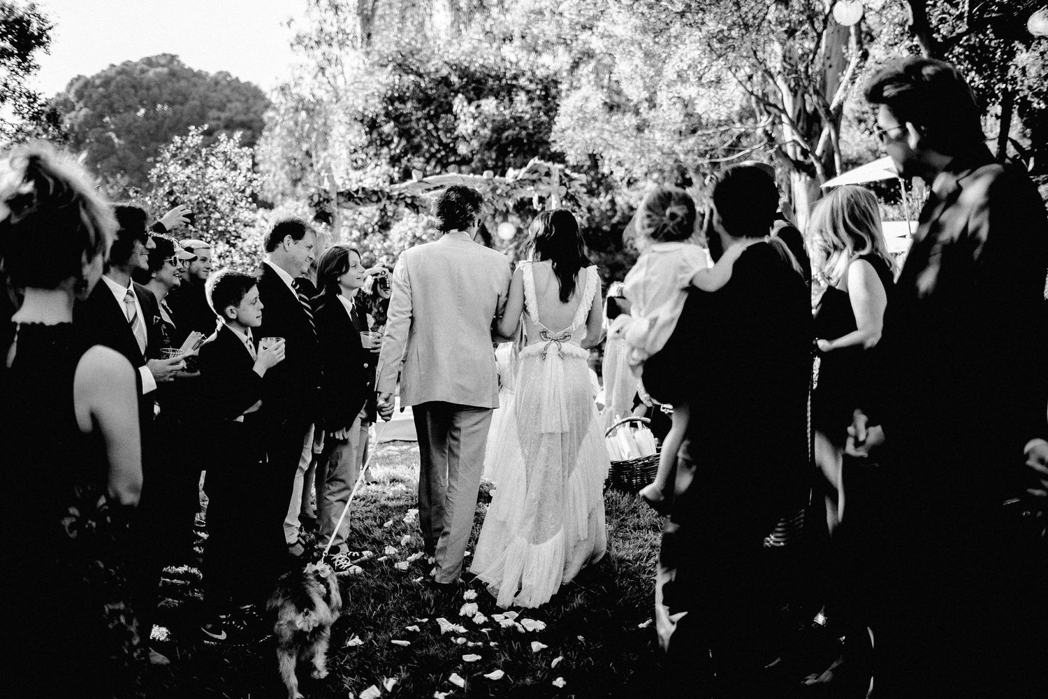 back shot of bride and father walking down aisle for wedding ceremony