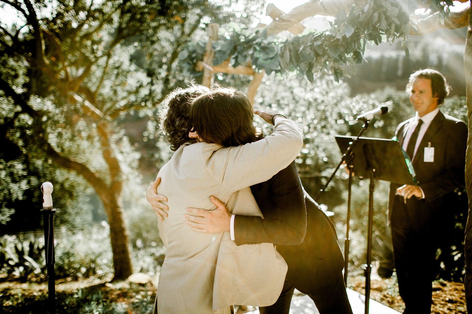 groom giving bride's father a hug