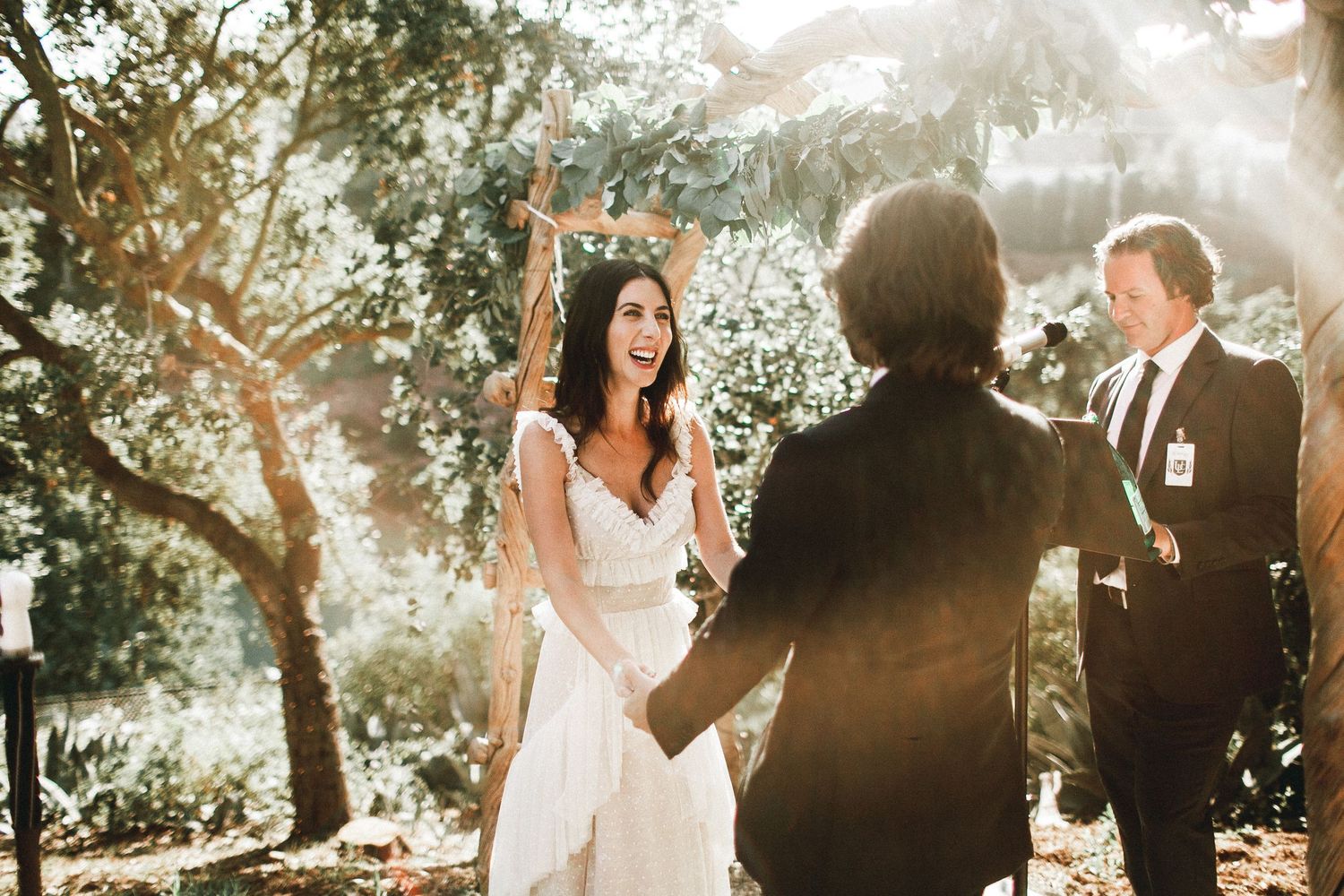 bride laughing while up at altar with groom