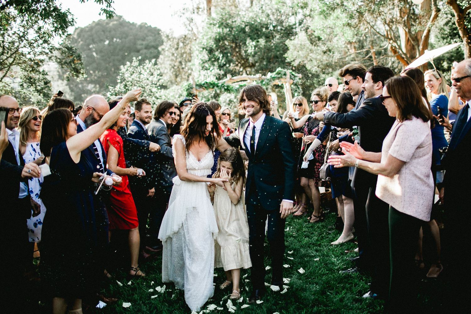 bride and groom exiting wedding ceremony being showered with lavender seeds