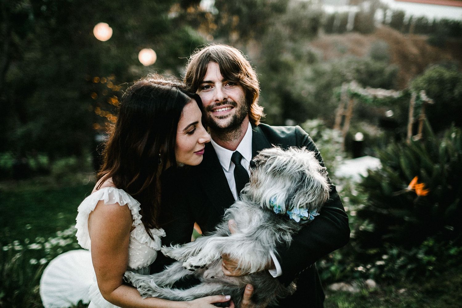 bride and groom portrait session looking at dog