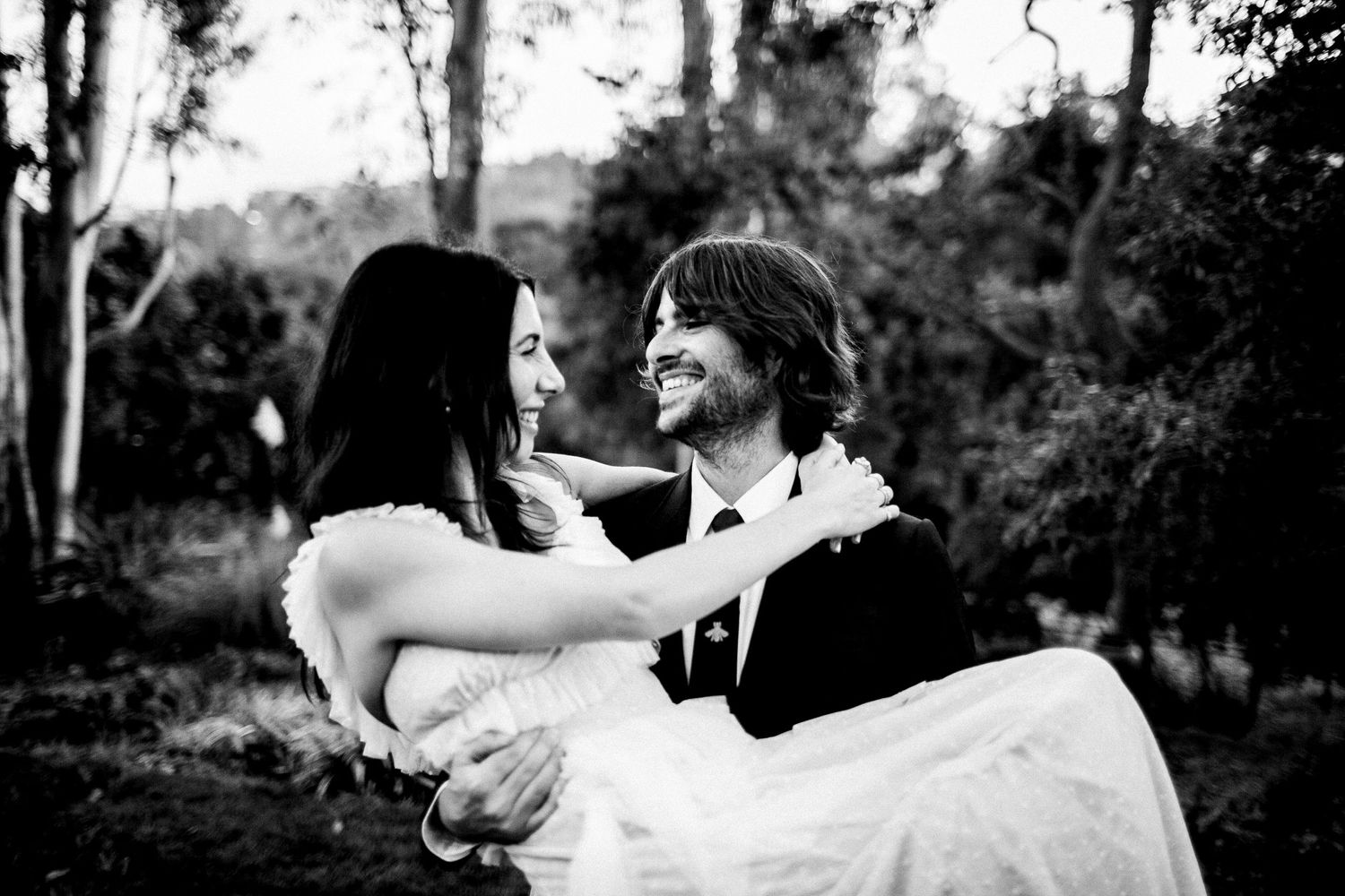 black and white photo of groom holding bride looking at each other