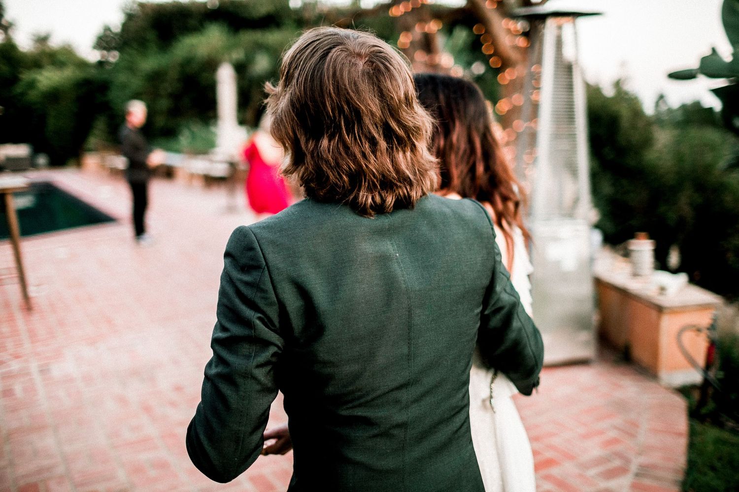 bride and groom walking towards reception