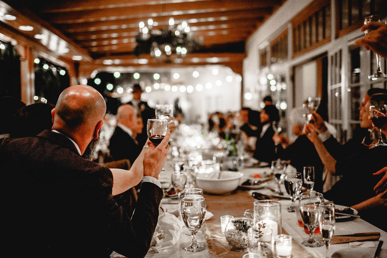 guests at reception table cheer-sing