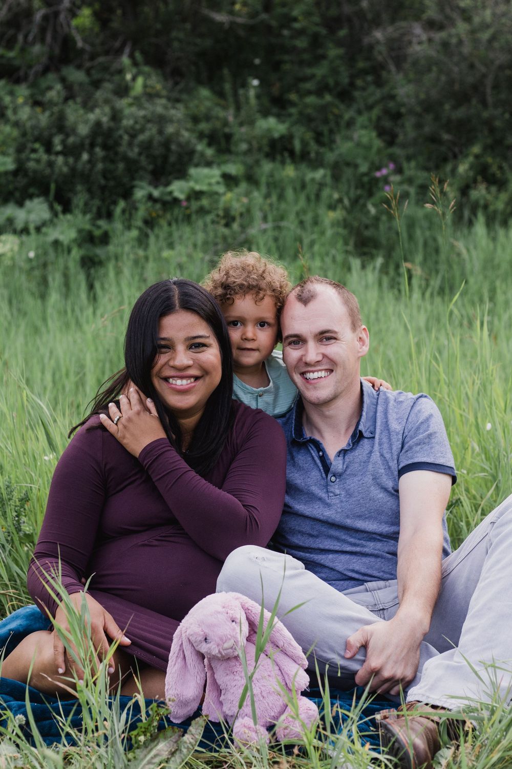 Family in a field smile