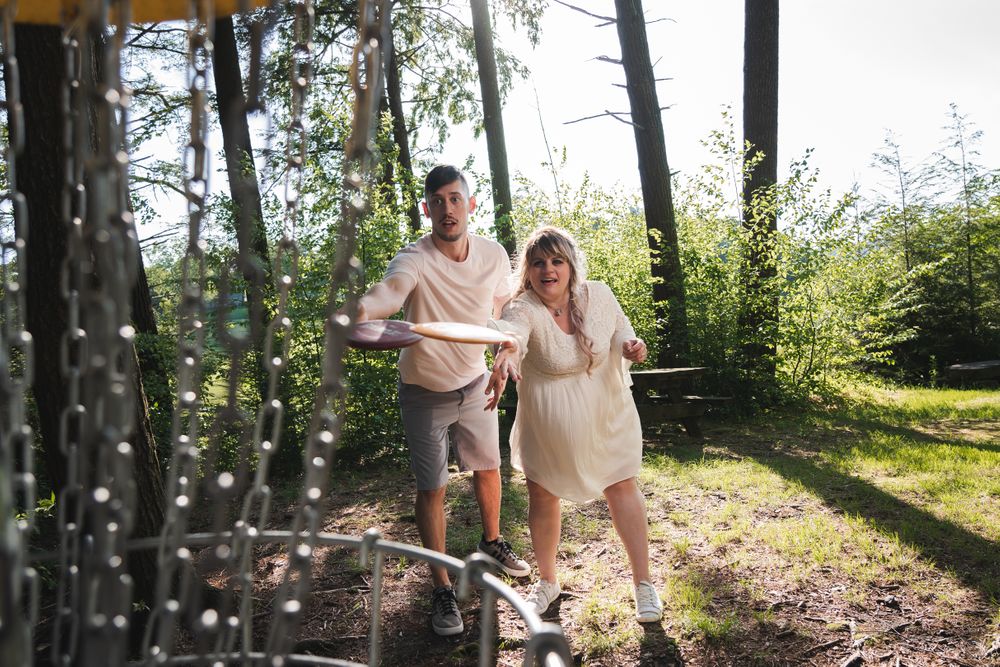 engaged couple playing disc golf at sweet arrow lake Schuylkill county pa