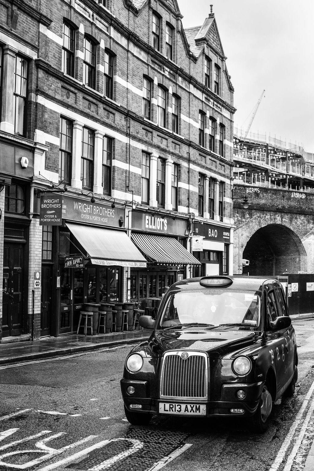 black and white street image of a London taxi in Boroughs Market area