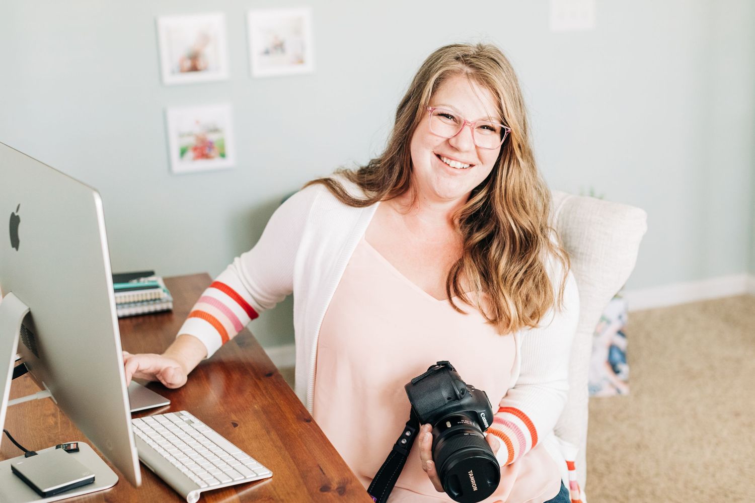 Charlotte family photographer sitting at her desk with her computer and camera