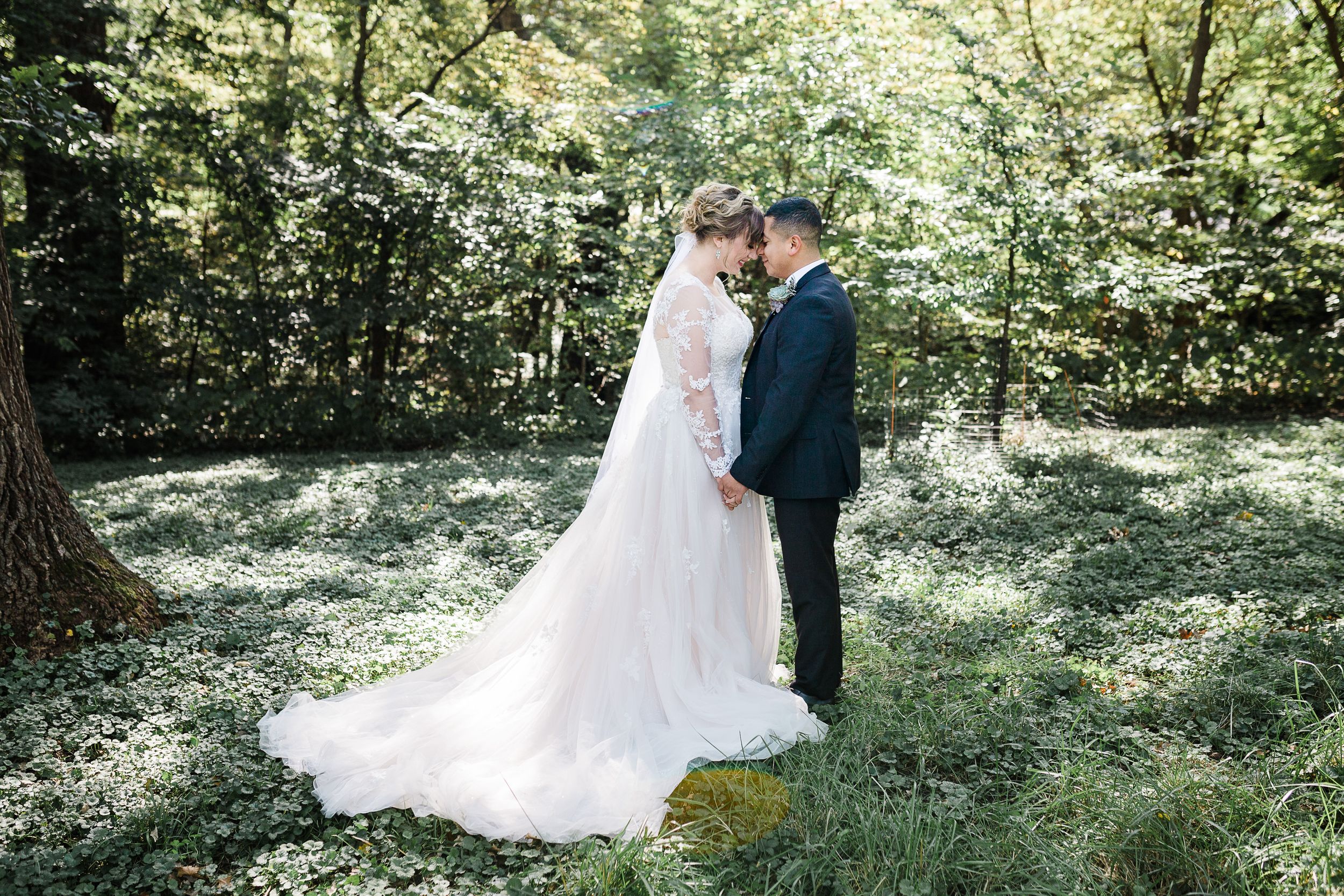 Bride and groom surrounded by trees and grass by Hudson Valley photographer