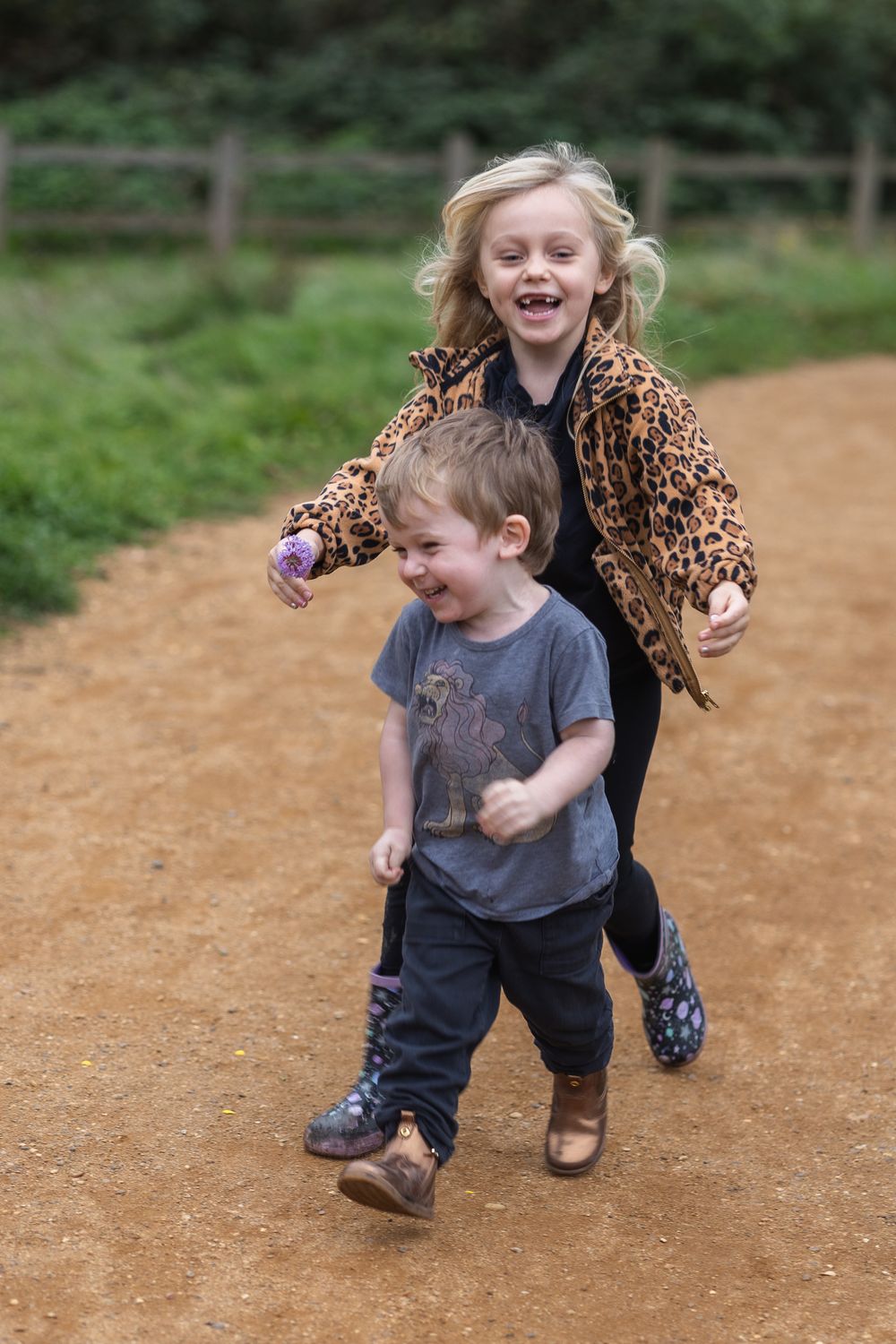 Siblings chasing each other in London Park