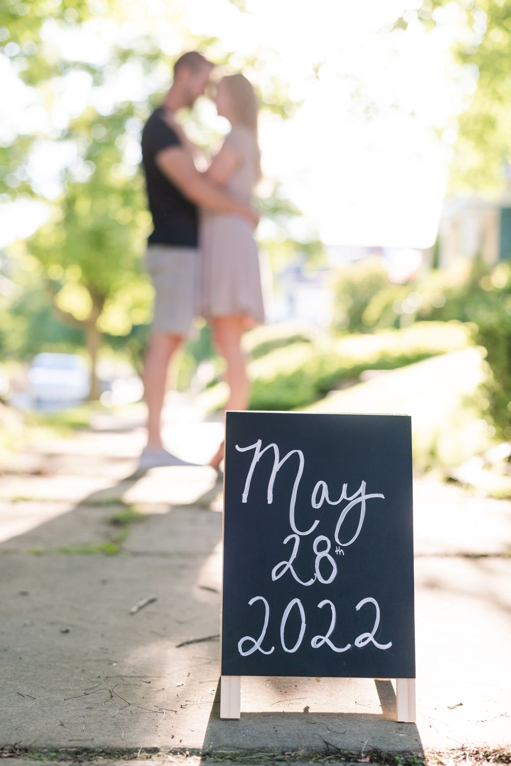 Save the date sign with couple in background for engagement in Franklin Pennsylvania