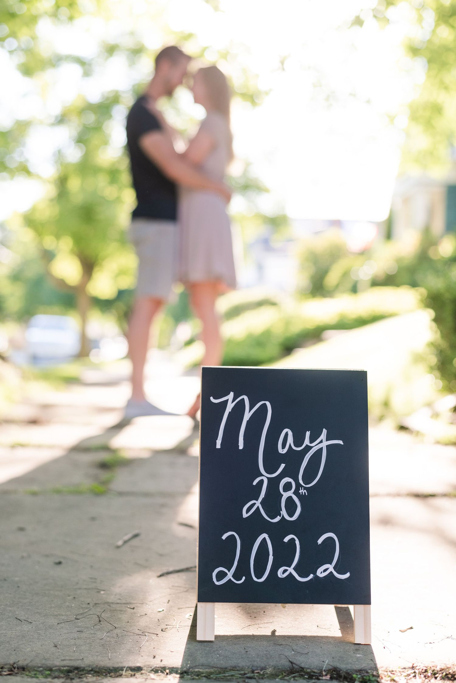 Save the date sign with couple in background for engagement in Franklin Pennsylvania