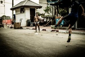 Young men plating Sepak takraw or kick volleyball in the back streets of Jakarta Indonesia