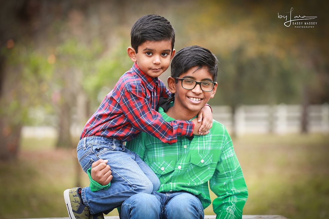 Two boys in a field by Sassy Massey Photography