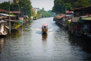 Long-tail boat on canal in Thailand