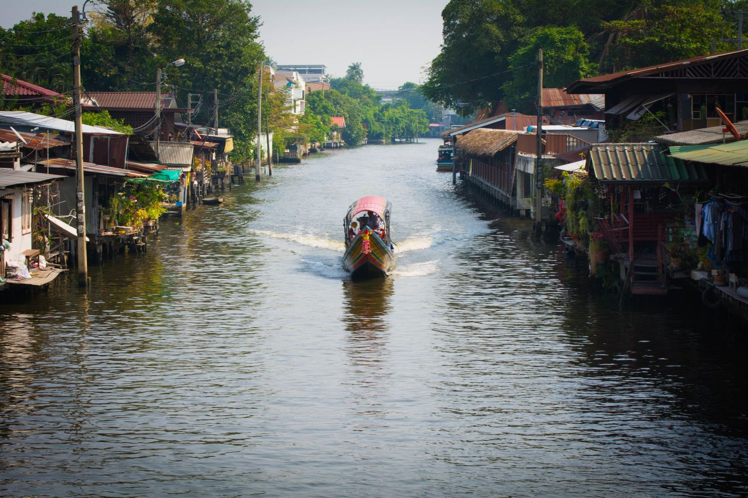 Long-tail boat on canal in Thailand