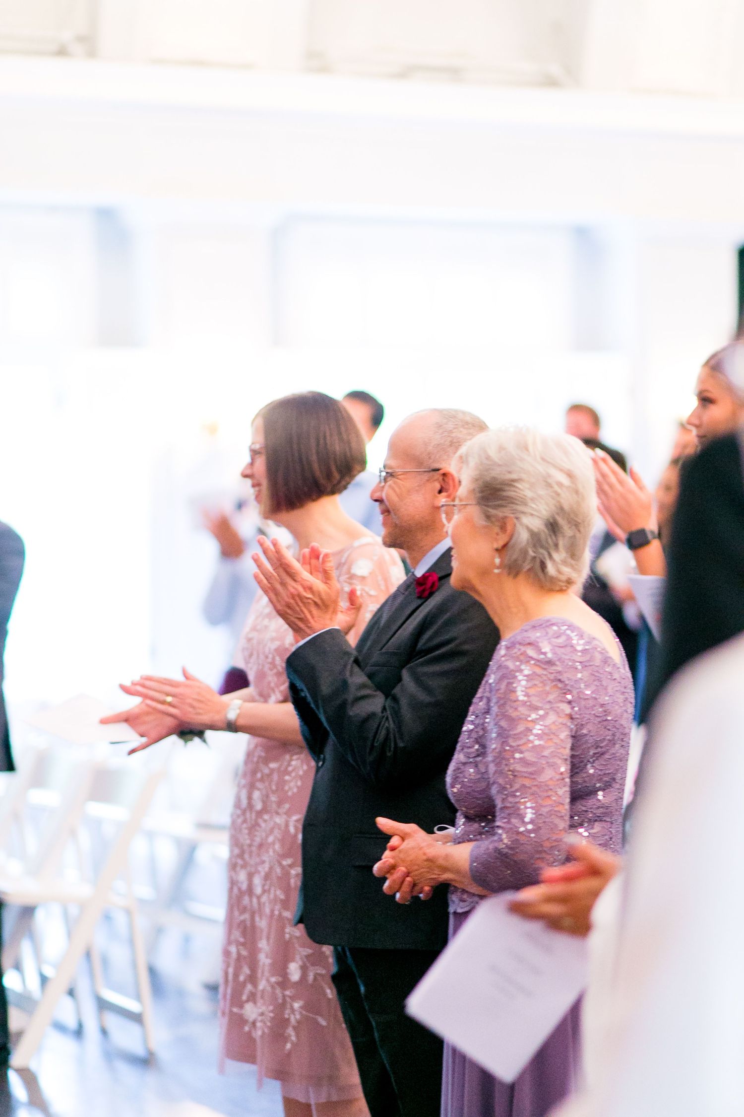 wedding guests clapping for bride and groom who were just married