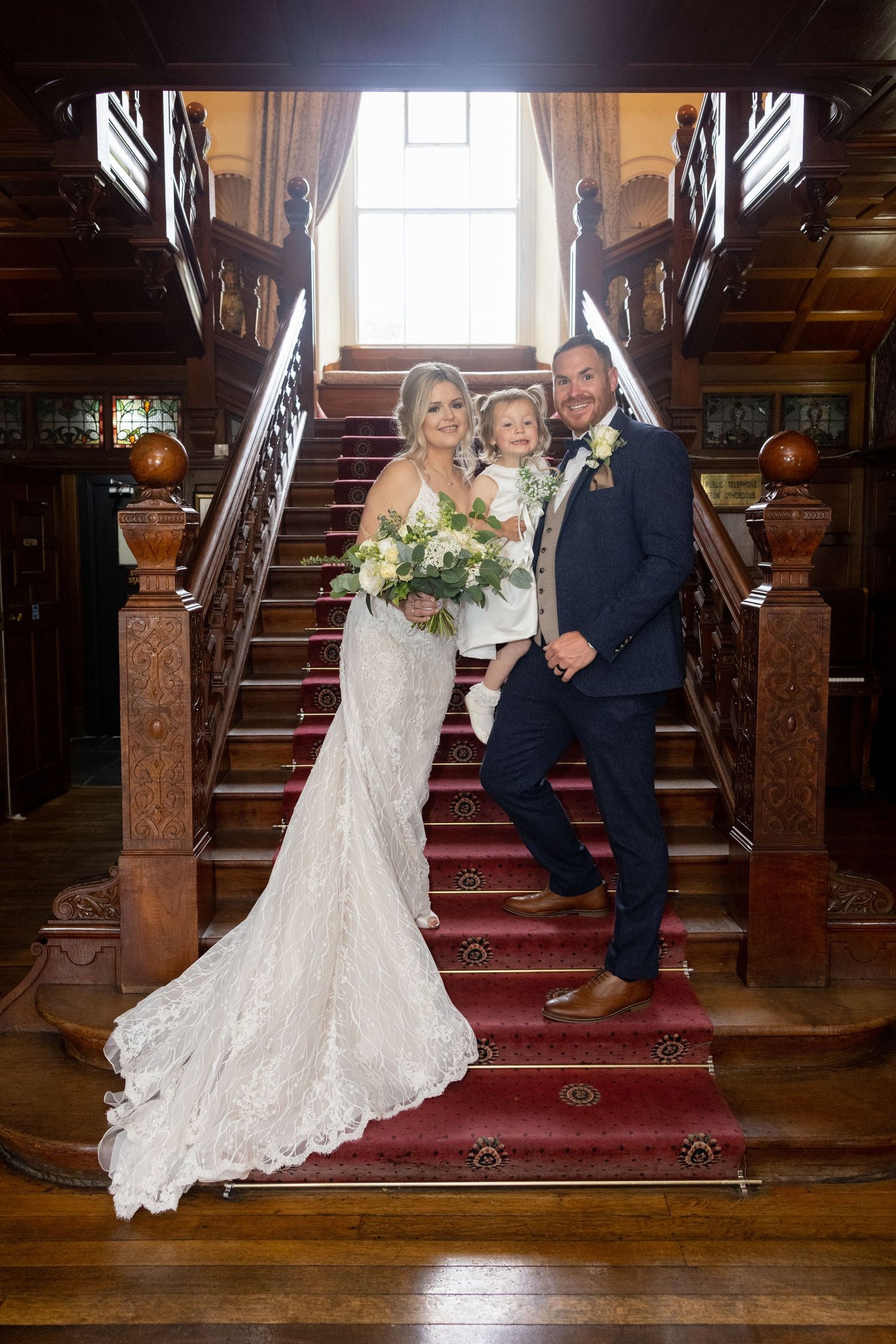 classic bride and groom posing on stairs at Court Colman Hotel