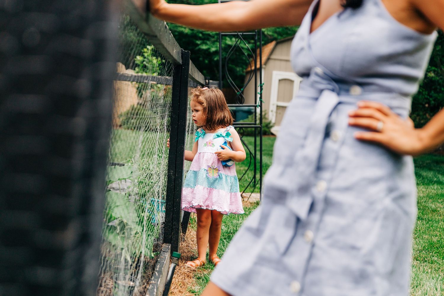 Little girl exploring her Charlotte, NC garden