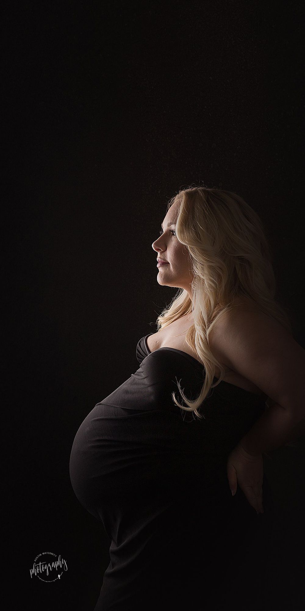 Austin Newborn Photography Maternity Portrait Modern maternity photo dramatic light black fabric wrapped mama