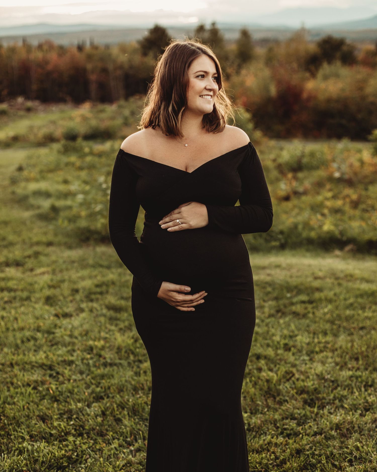 Professional outdoor maternity photo mother in black dress