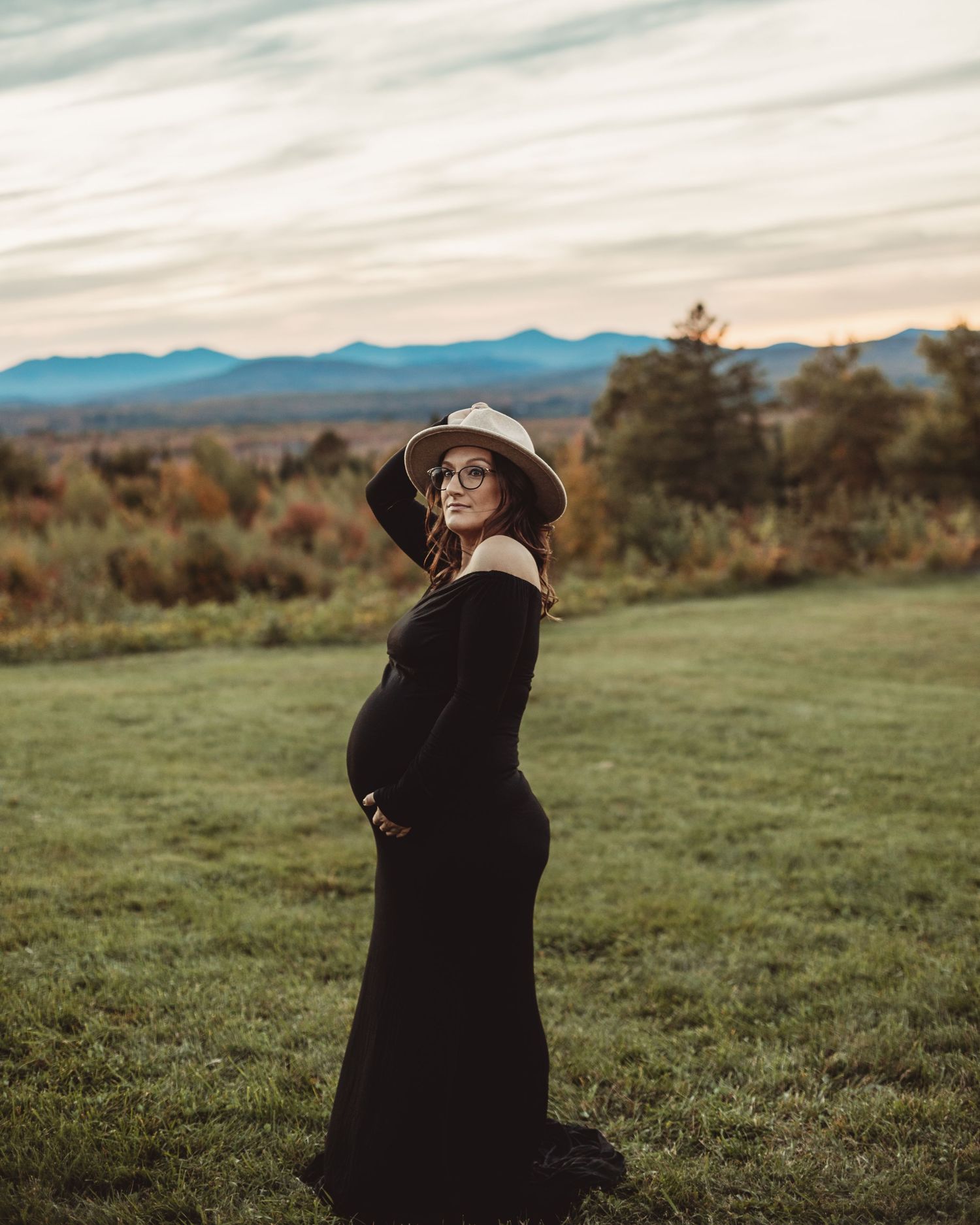 Professional outdoor maternity photo mother in black dress