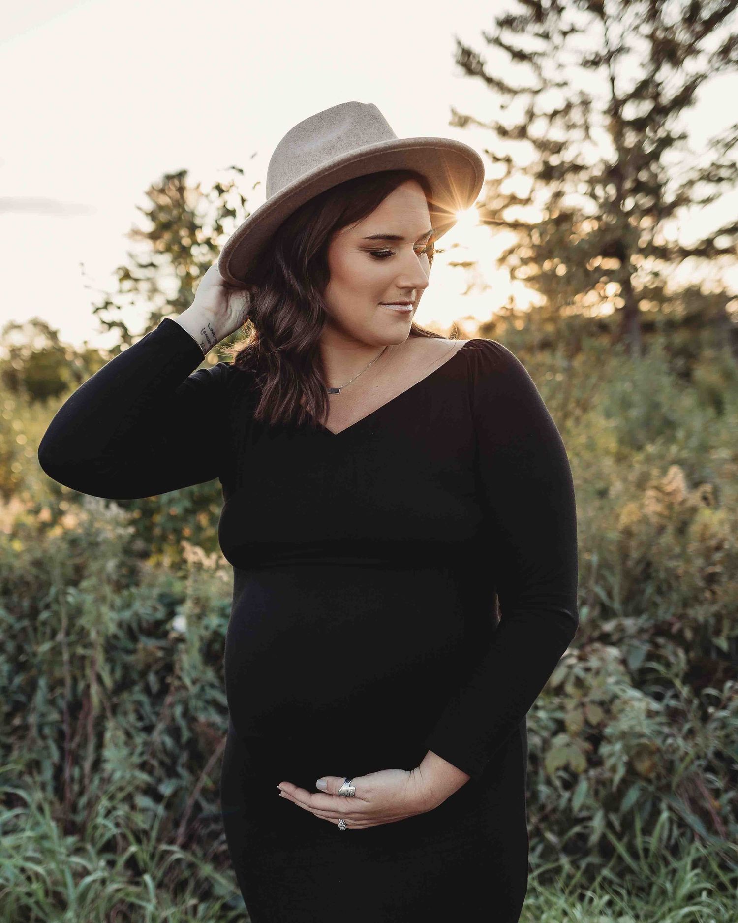 Professional outdoor beach maternity photo mother in black dress
