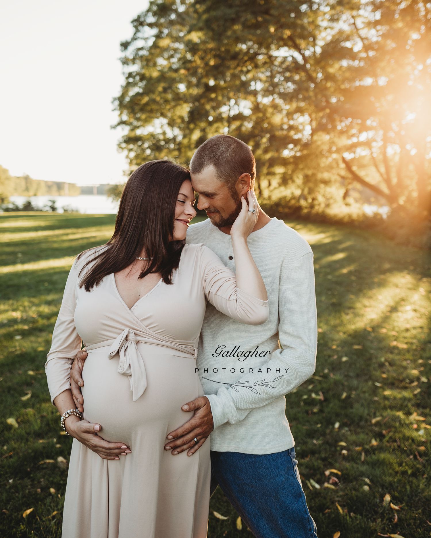 Professional outdoor maternity photo mother in blue dress off-white dress with father
