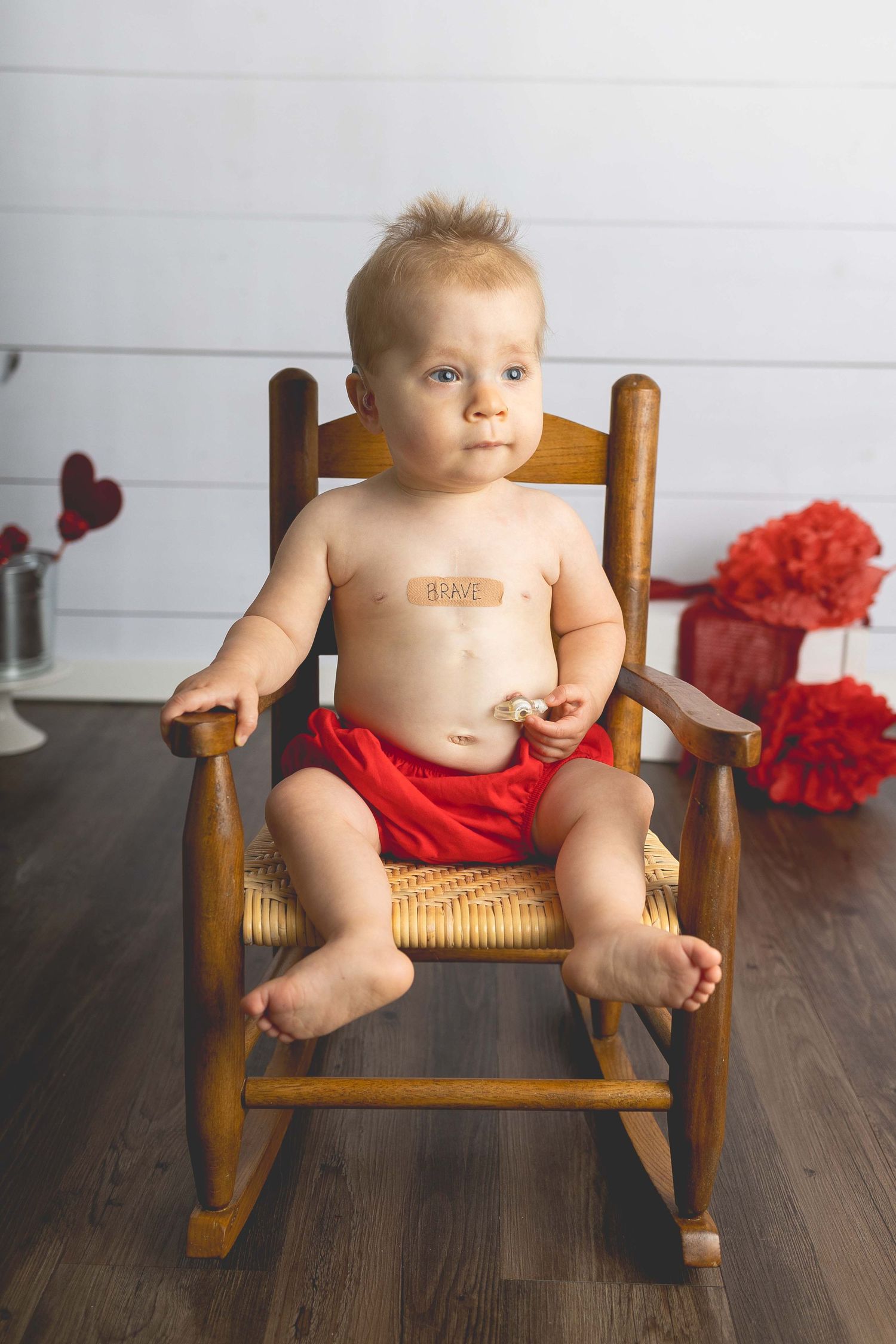 heart warrior photoshoot little boy playing with feeding tube