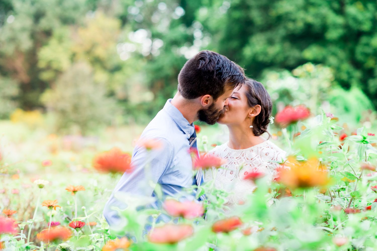 married couple kidding in wildflower field