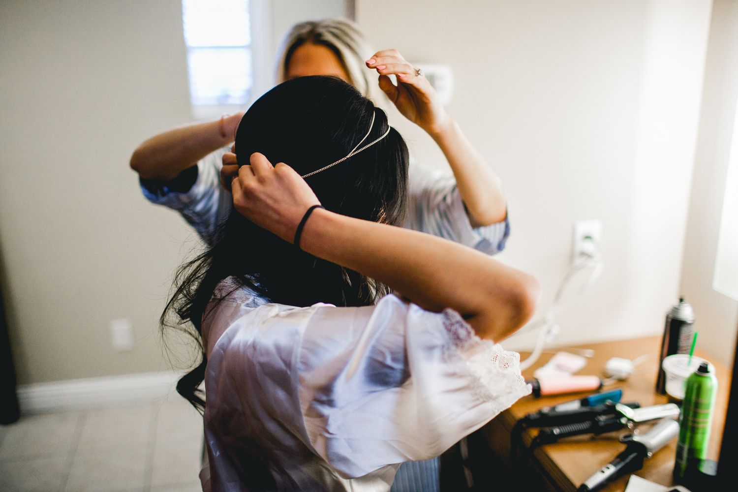 bride adjusting crown on hair preparation