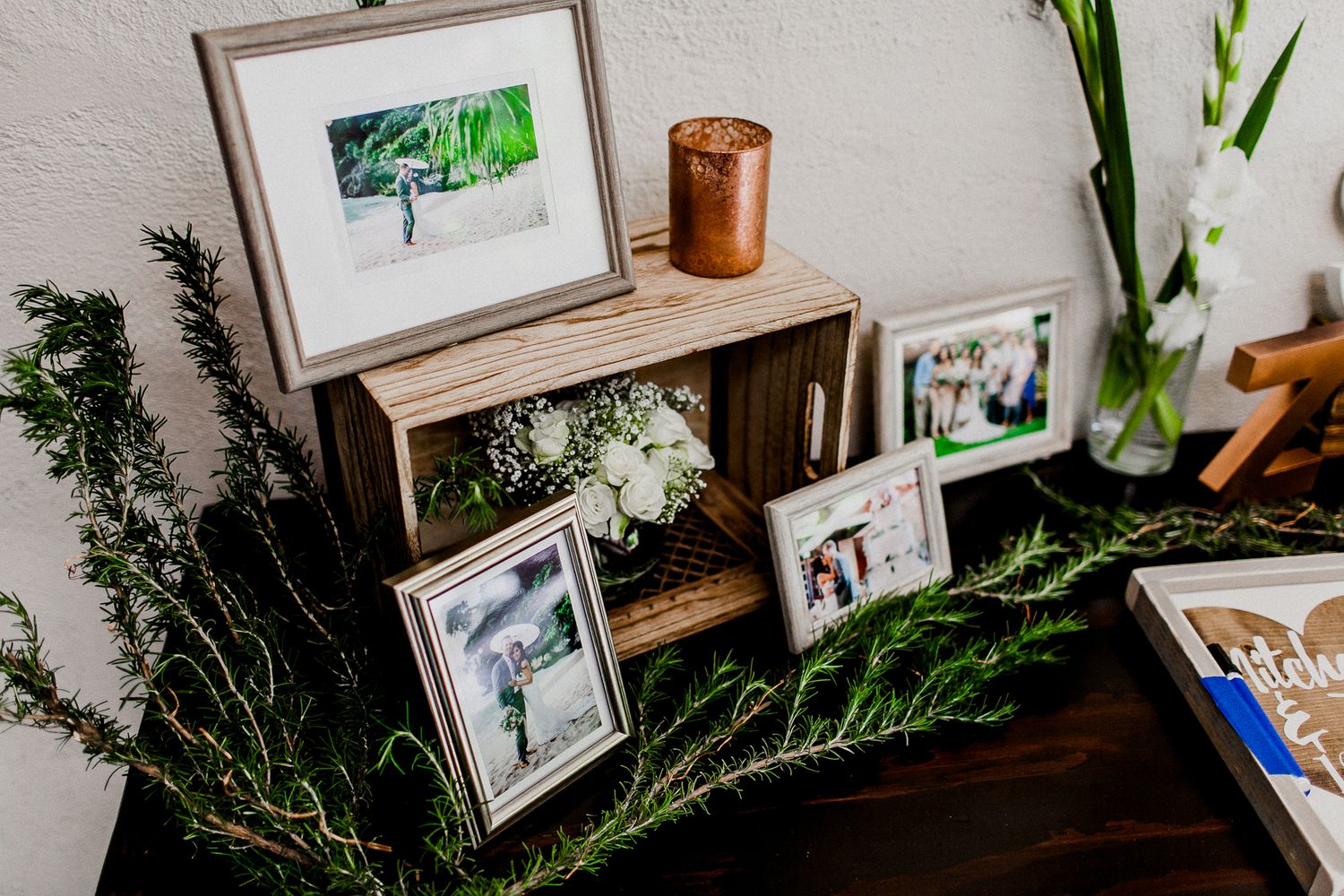 picture frames and floral design for welcome table