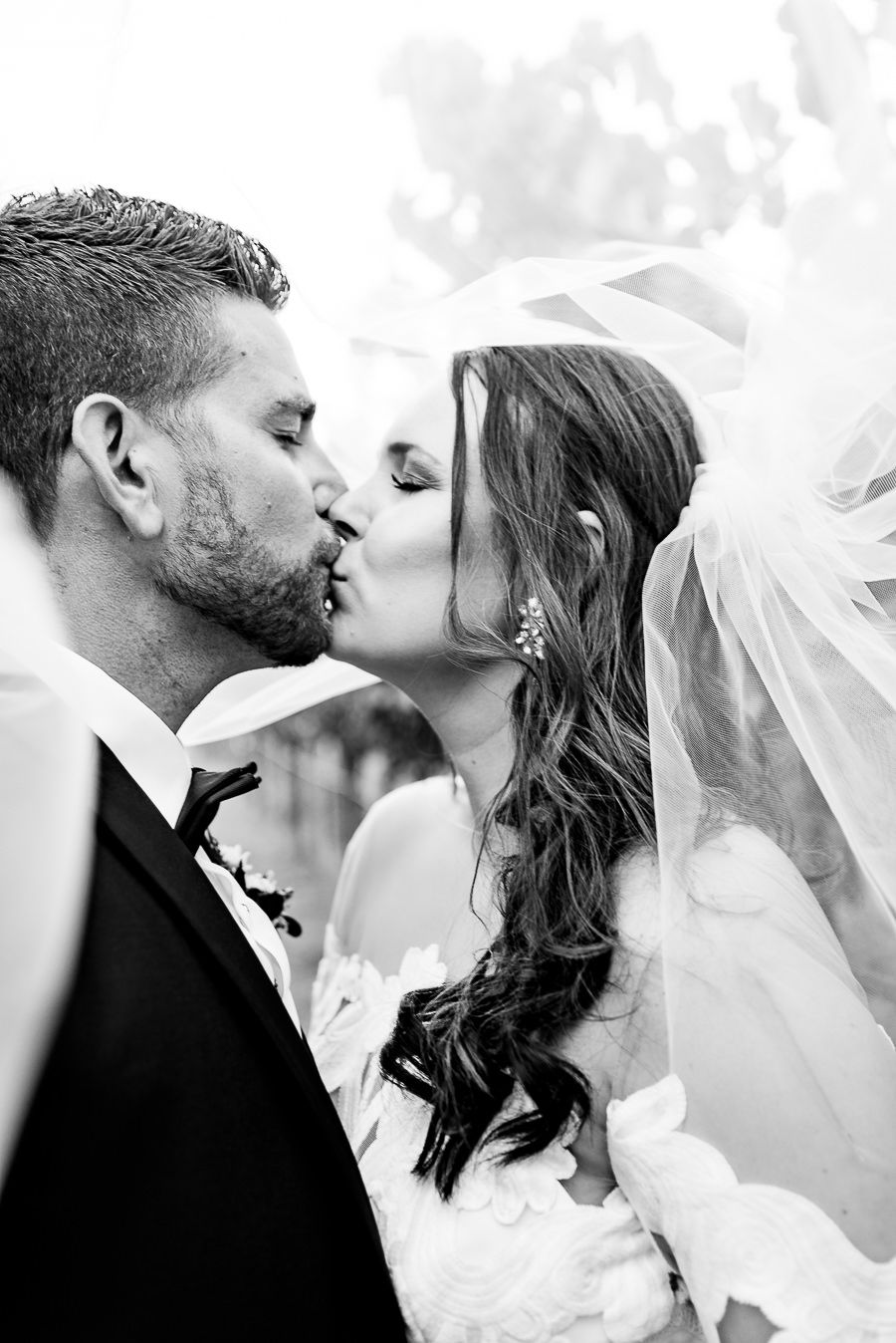 Bride and groom kiss under veil at Pennyroyal Farm wedding in Northern California