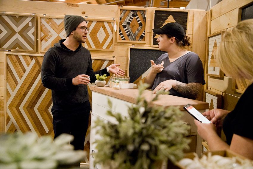 Pinology Puyallup Evergreen Root NW Booth owner and other booth owner chatting hand made candles and wood art