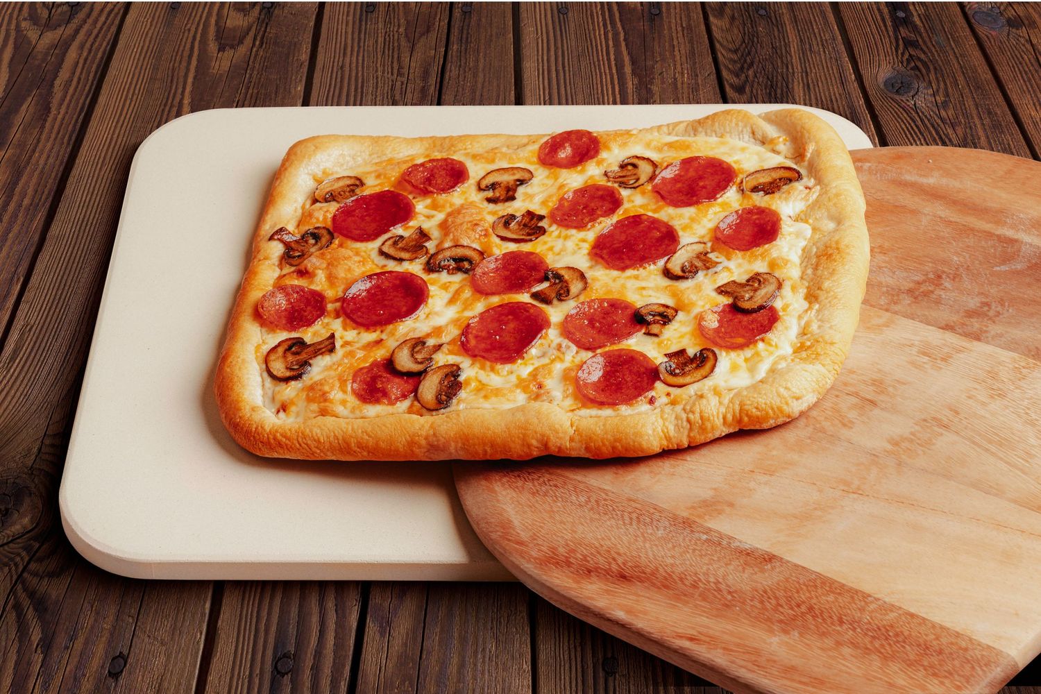 Fresh pepperoni pizza with melted cheese on a wooden cutting board.