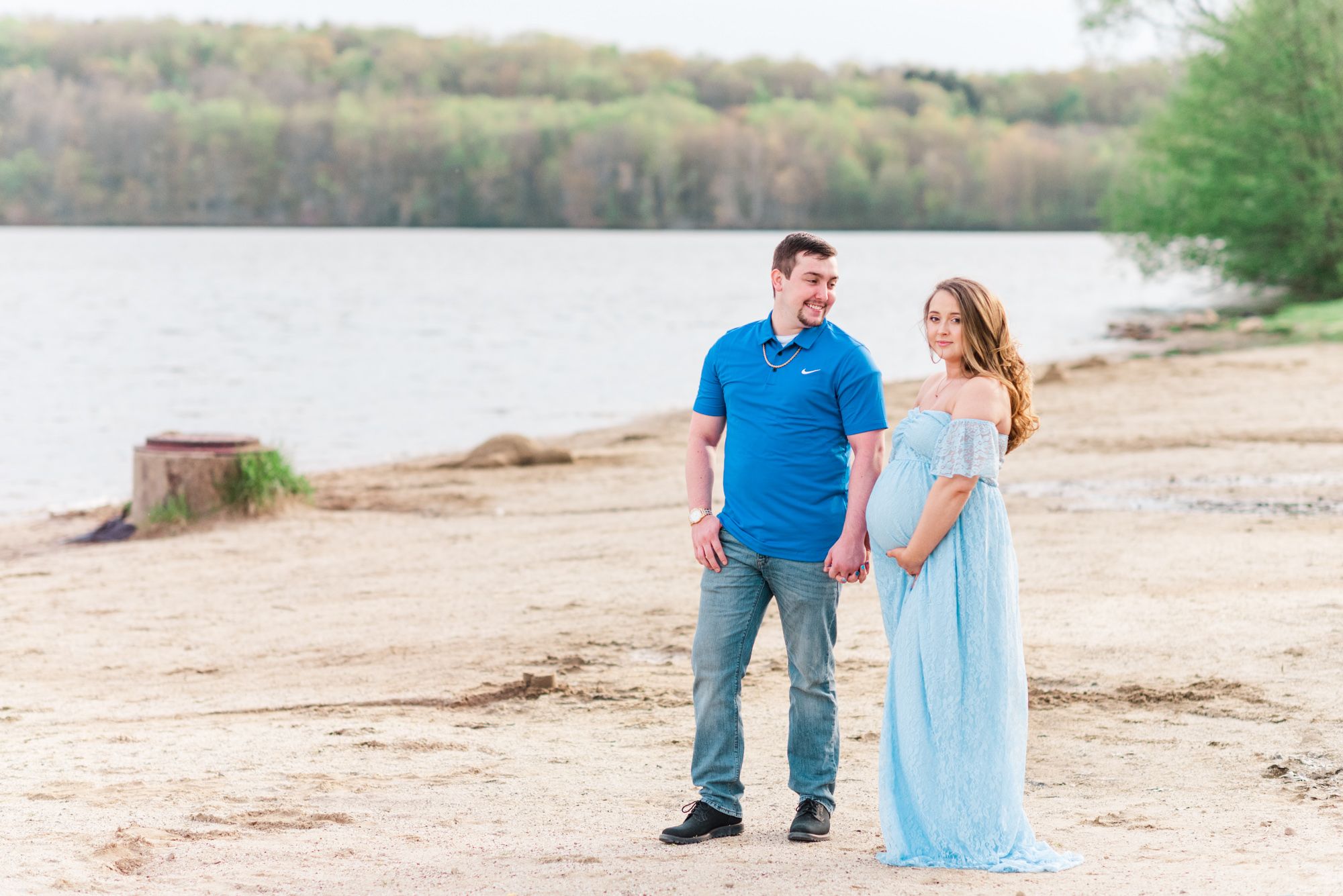Maternity session with couple on beach in golden hour sunlight at Moraine State Park, Pennsylvania