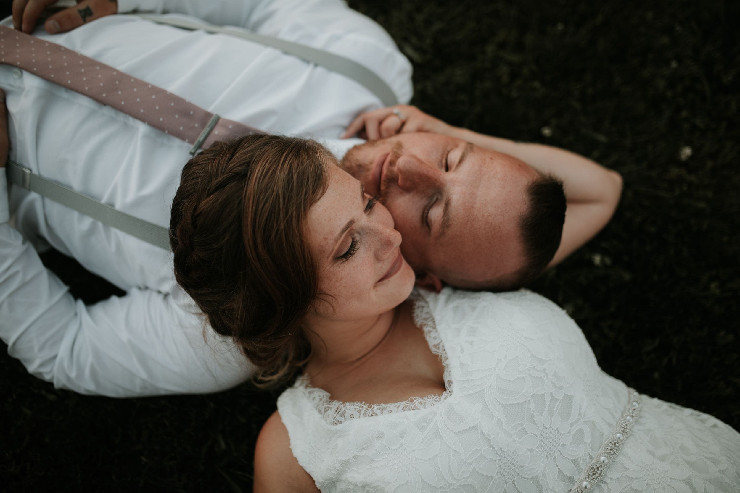 bride and groom resting their heads on each others shoulders