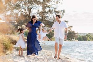 A family of 4 playing along the shore during their maternity shoot in Perth Western Australia