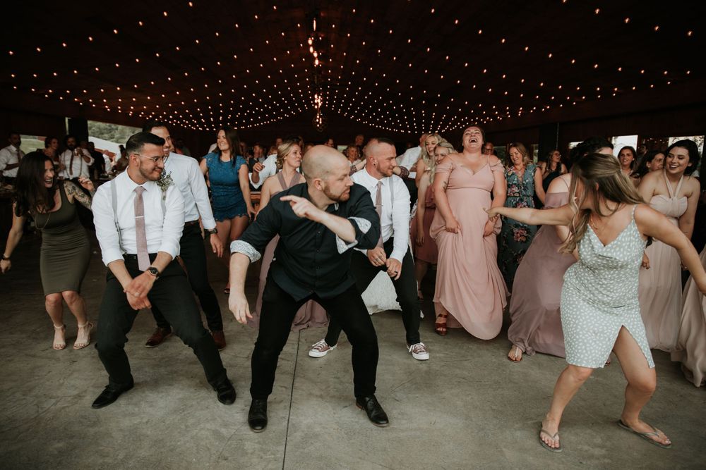 guests dancing at a finger lakes wedding at climbing bines