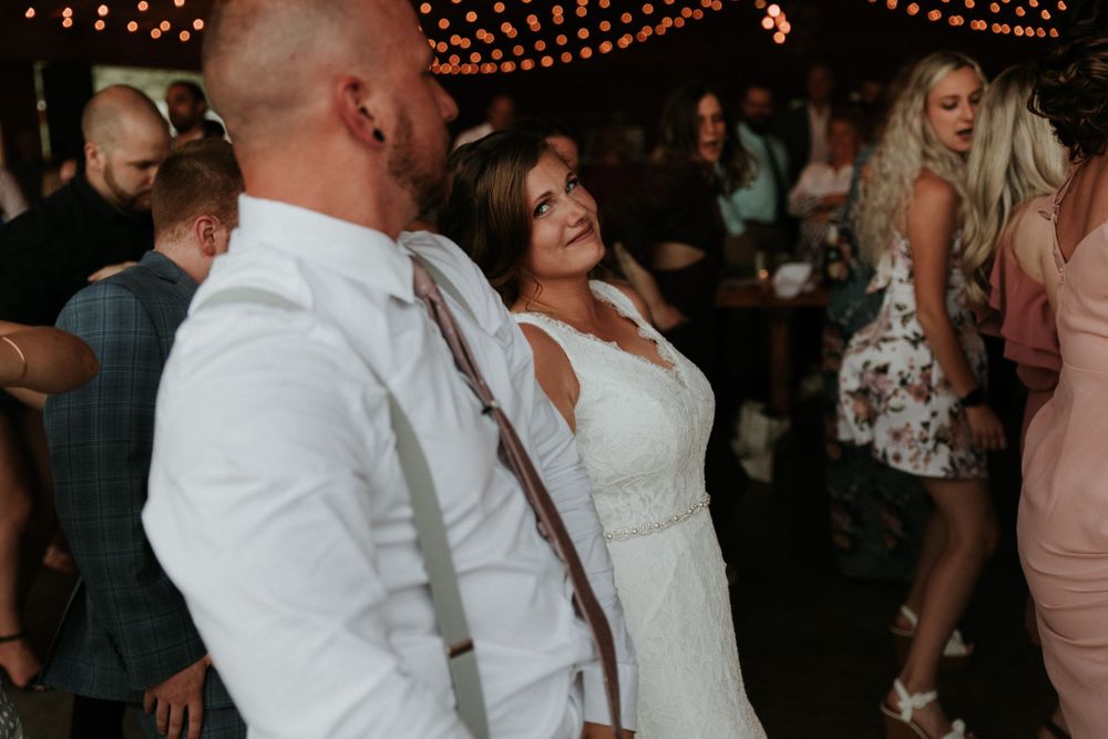 bride looking at groom while dancing at climbing bines