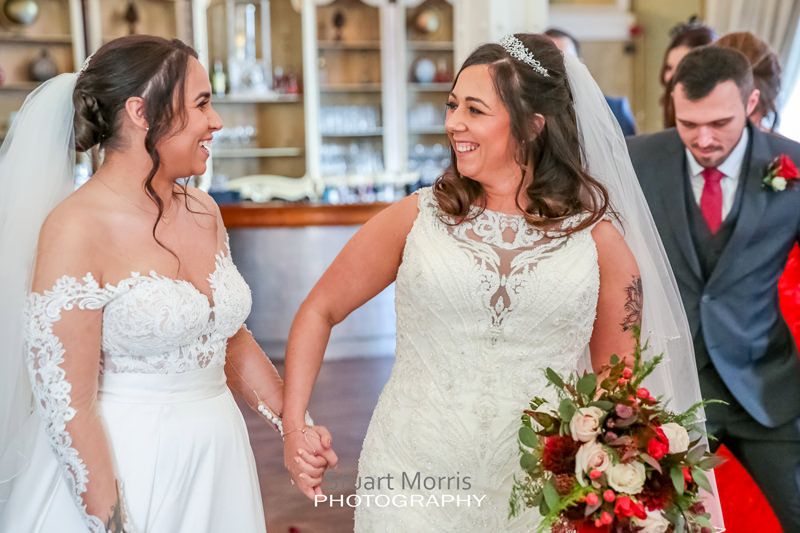 brides holding hands during the ceremony at 30 james street