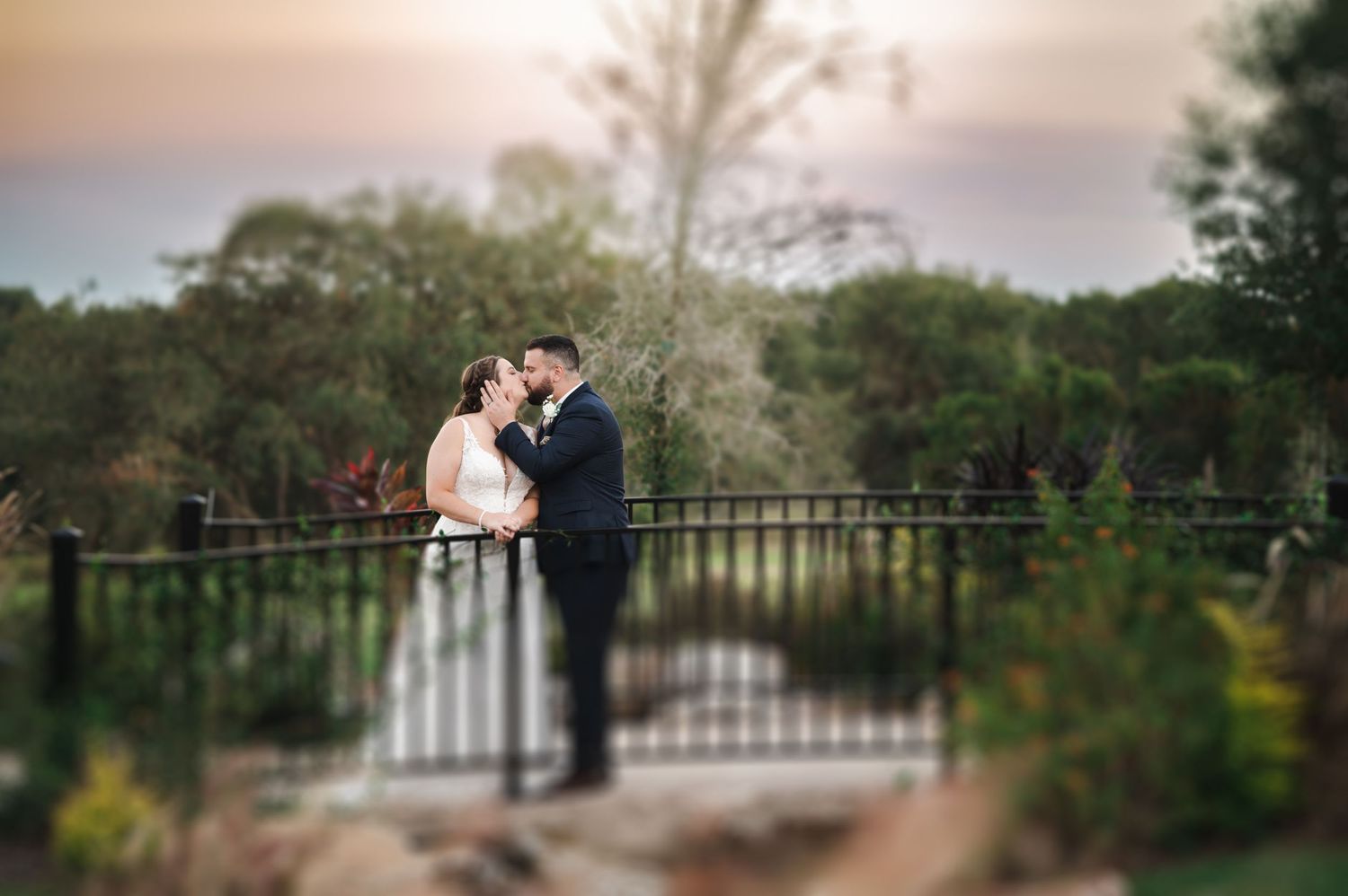 newly weds bride groom bridge kiss