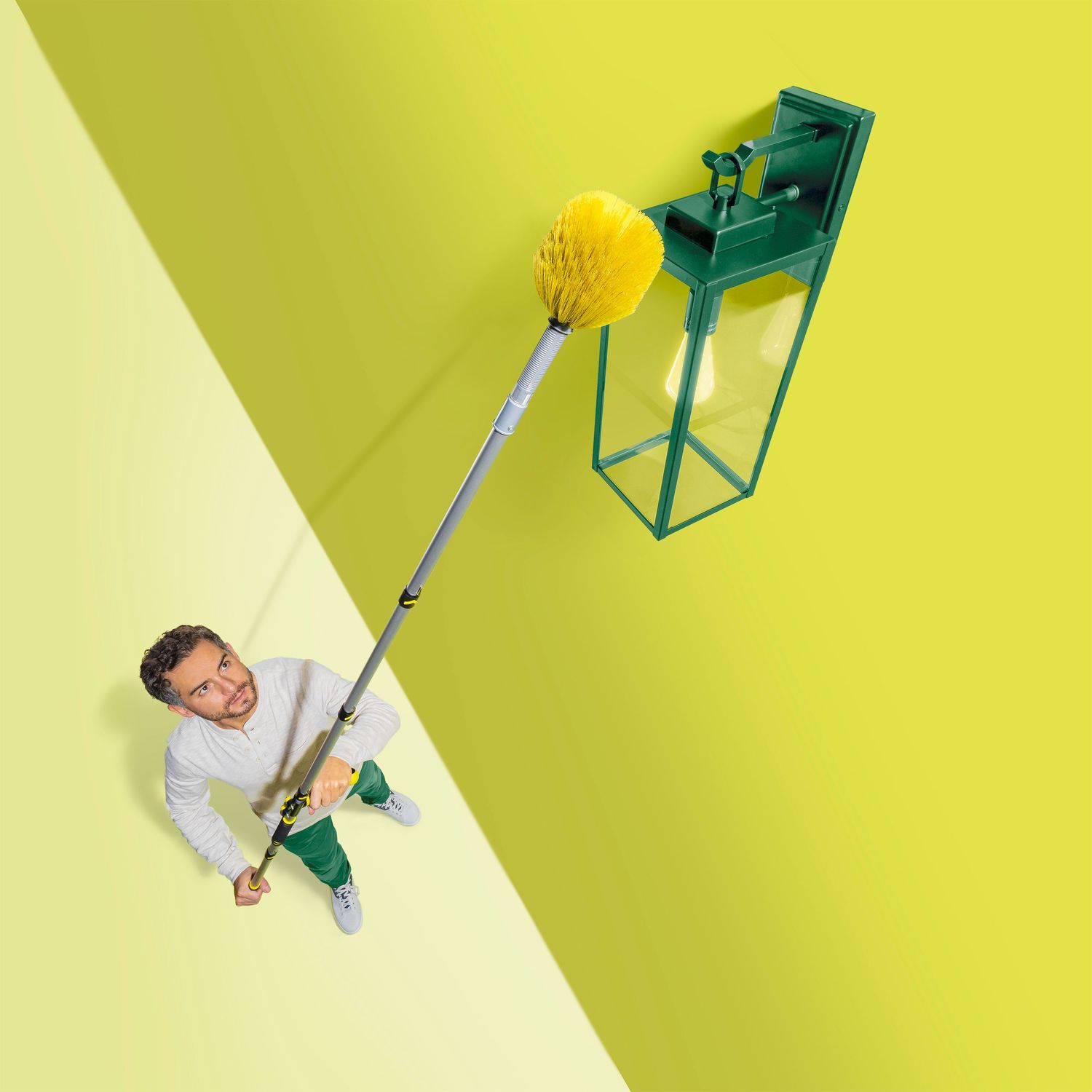 Creative shot of cleaning service with extending mop reaching green mailbox on yellow background.