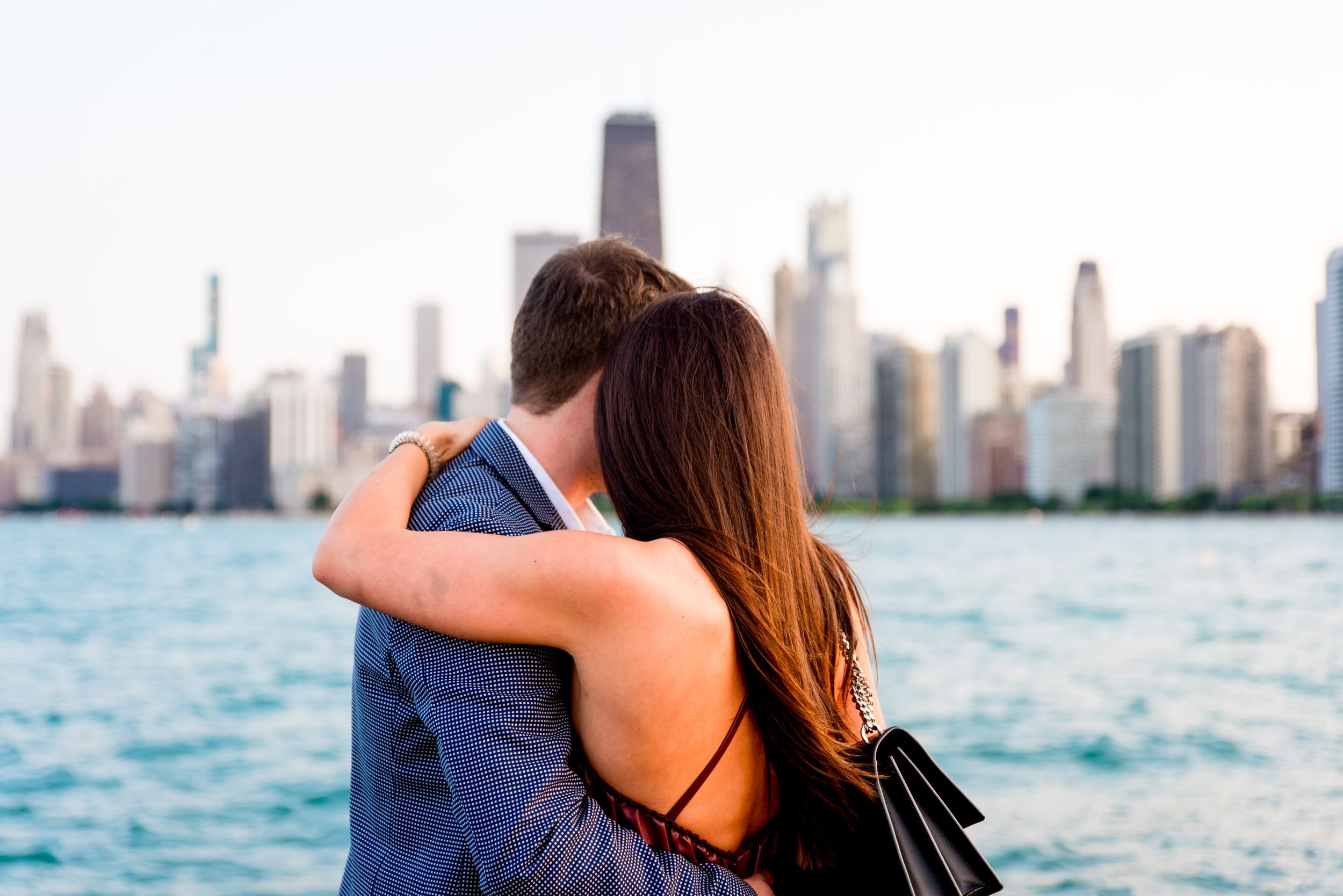 man and woman hugging after Chicago proposal at North Avenue Beach pier