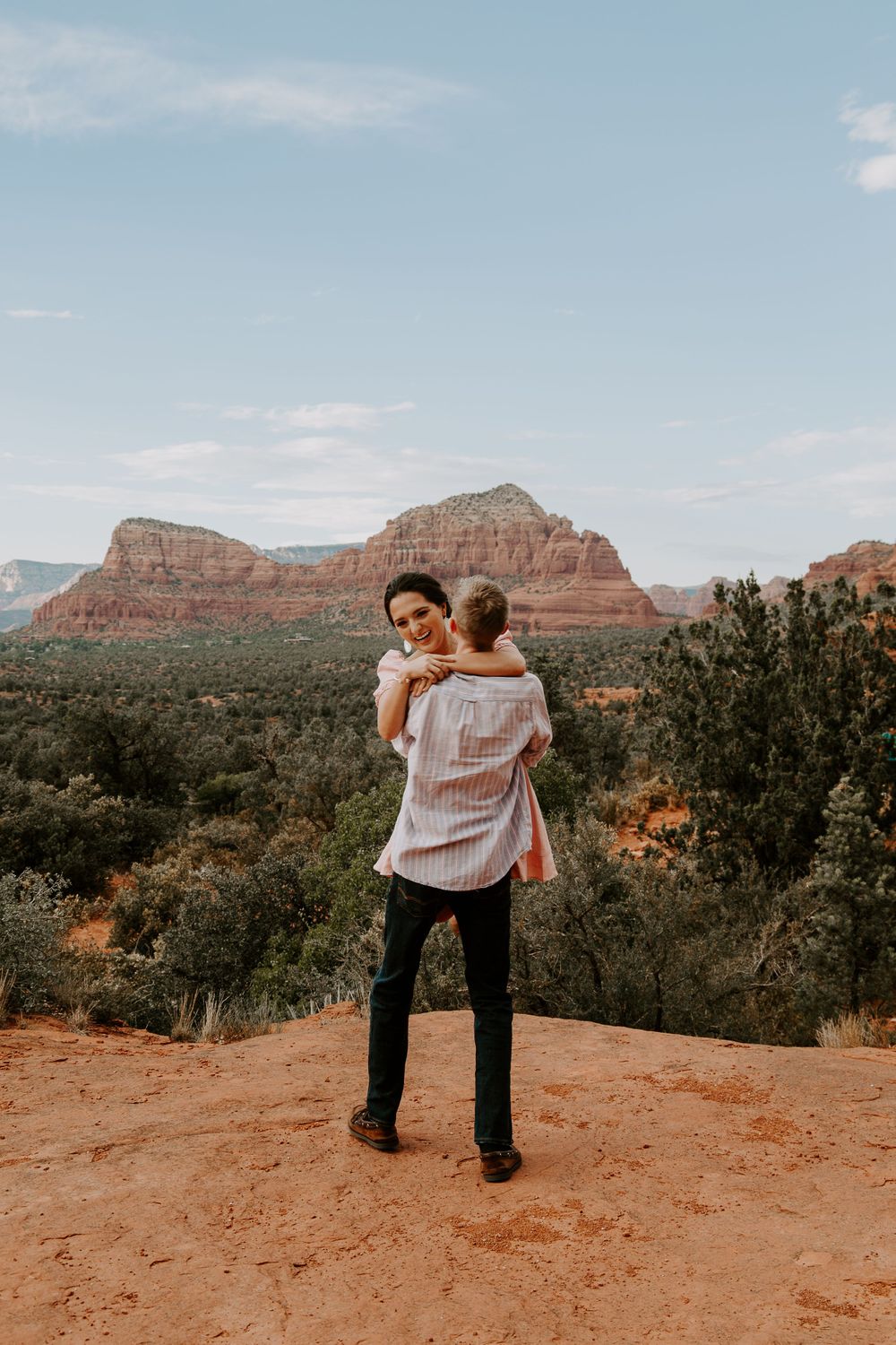 man holding a woman and spinning her in circles during their engagement session