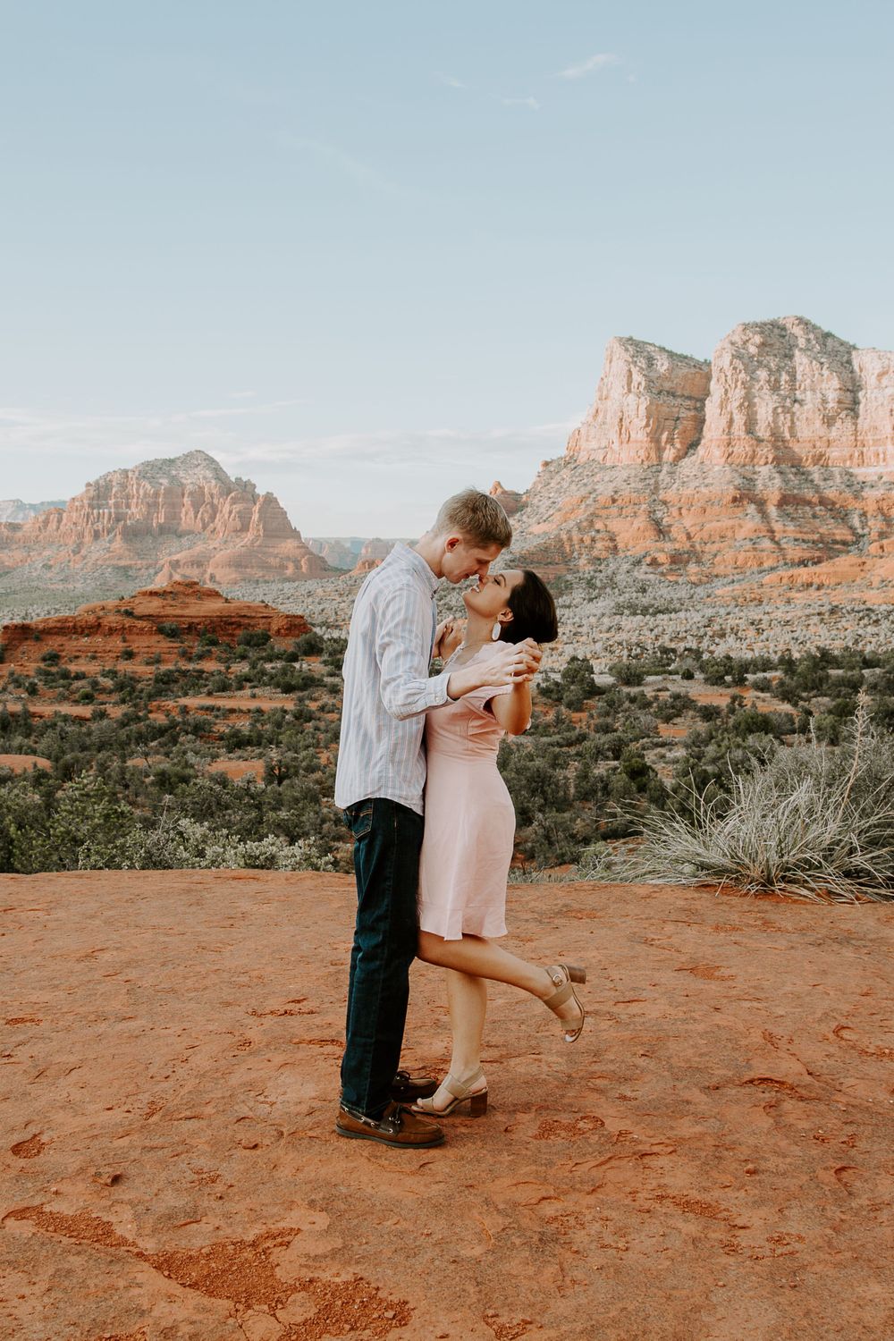 couple sharing a kiss at Bell Rock in Sedona, Arizona