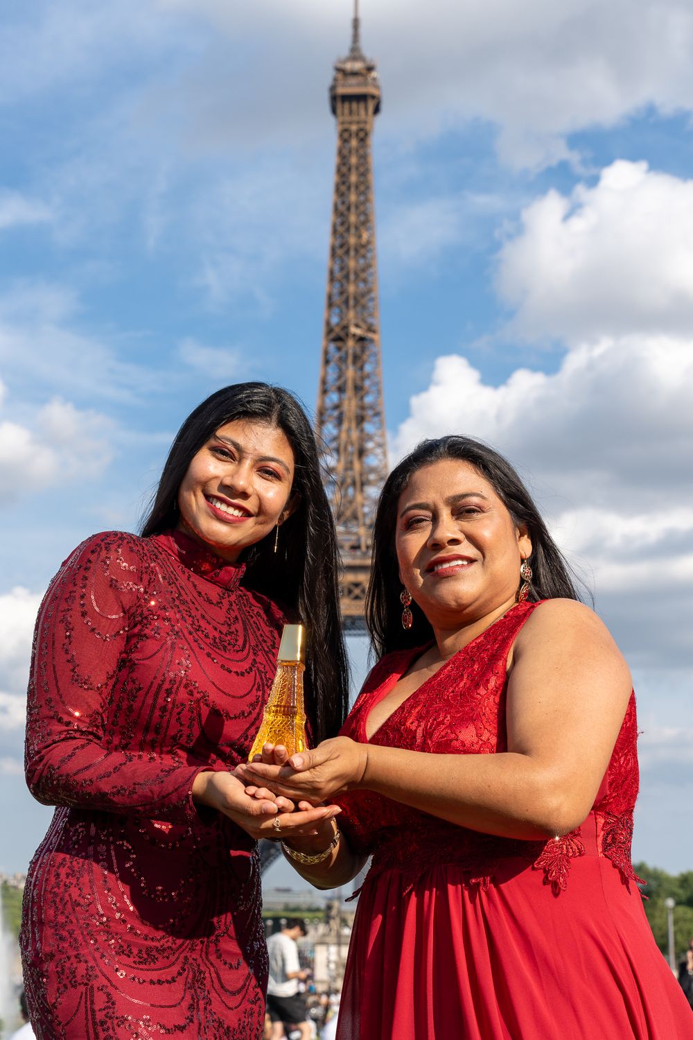 Family posing in Paris, captured through travel photography, emphasizing the essence of the city and a touch of perfume.