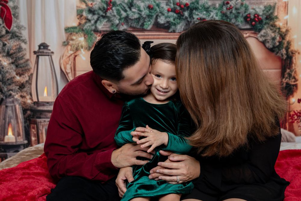 Intimate family moment captured during holiday photoshoot with Christmas decorations.