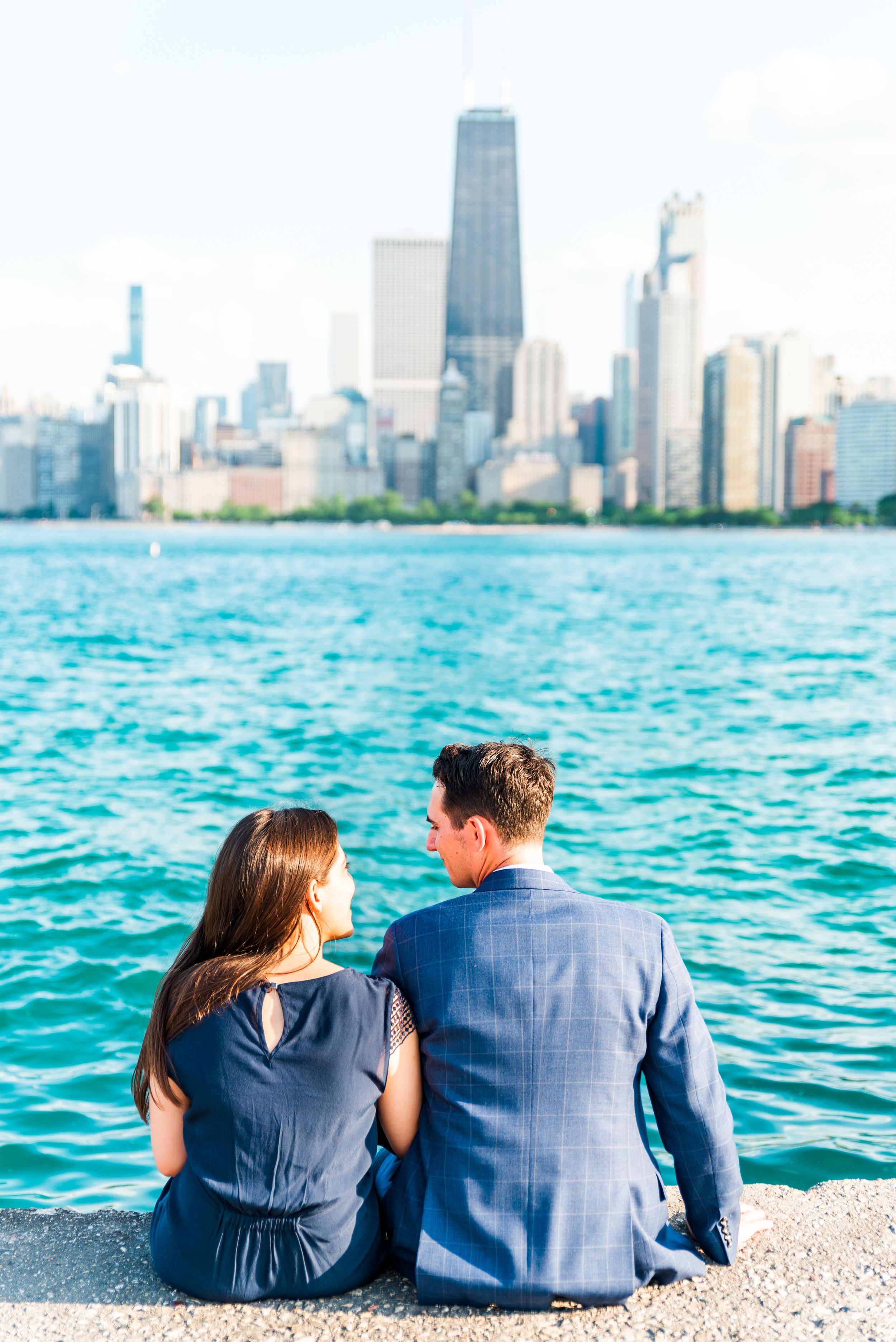 man and woman sitting in front of Hancock tower after North Avenue Beach proposal