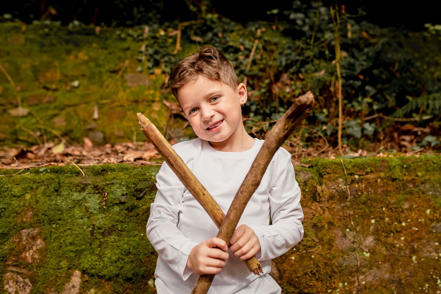 Boy doing nature play during family lifestyle photoshoot